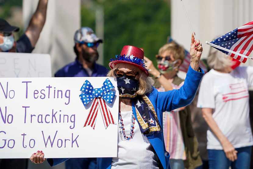 Protesters rally against stay-at-home orders at Dealey Plaza on Tuesday, April 21, 2020. The...