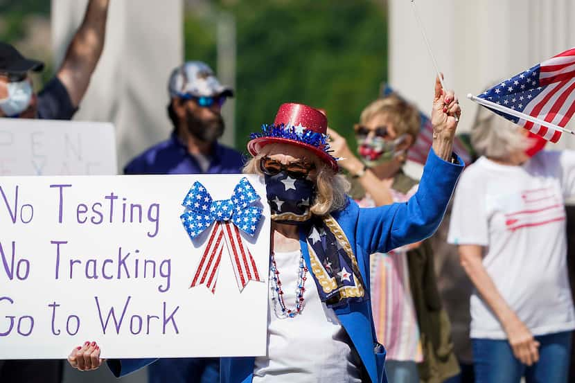 Protesters rally against stay-at-home orders at Dealey Plaza on Tuesday.