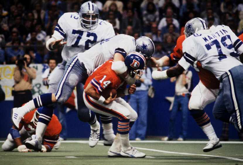 The Dallas Cowboys 'DoomsDay' defense, including Randy White (54 - atop the Denver QB); Ed...