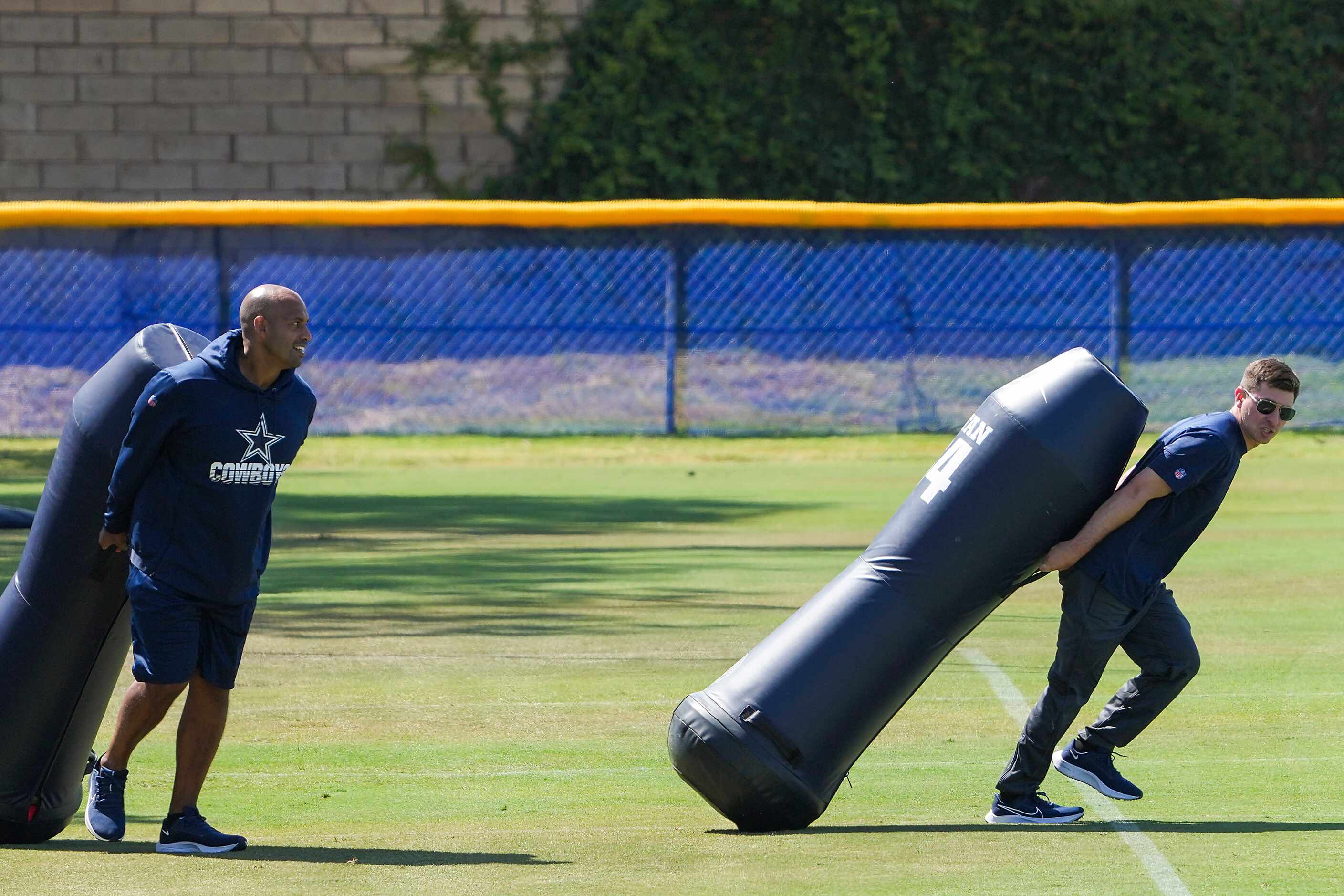 Dallas Cowboys staff set up the field before the first practice of the team’s training camp...