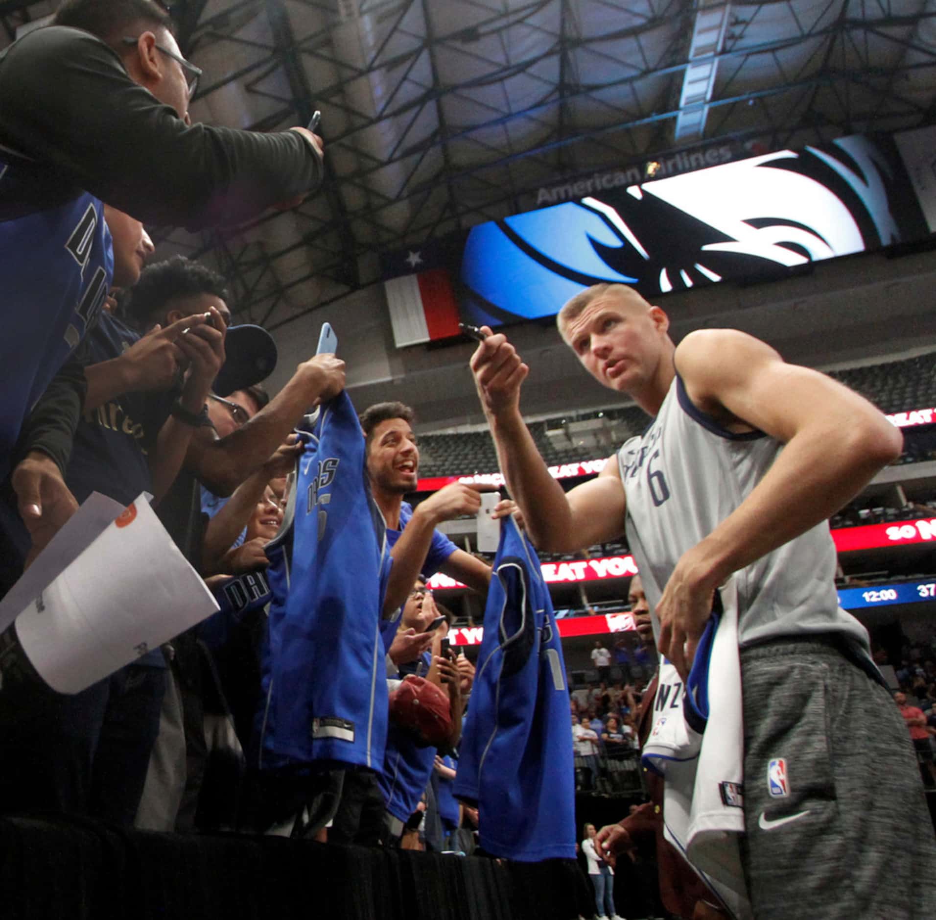 Dallas Mavericks center Kristaps Porzingis (6) autographs Mavericks gear for fans following...