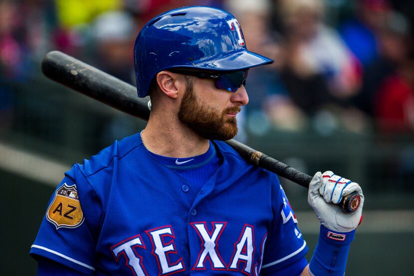 Texas Rangers catcher Jonathan Lucroy (25) warms up before batting during the first inning...