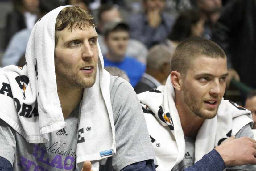 Dallas Mavericks forwards Dirk Nowitzki (41) and Chandler Parsons (25) watch from the bench...