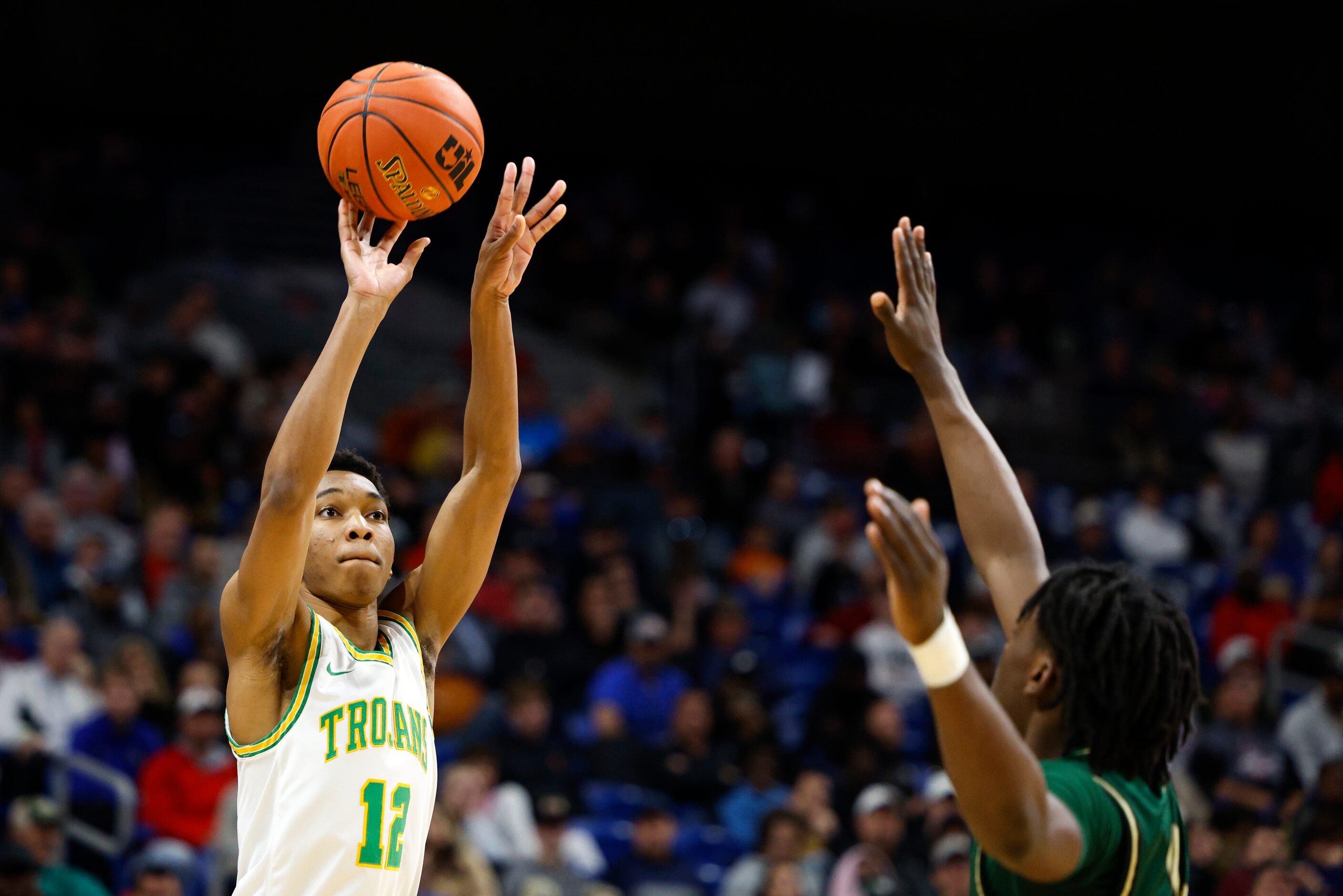 Madison guard Brandon Patterson (12) shoots the ball over San Antonio Cole forward Dre Ray...