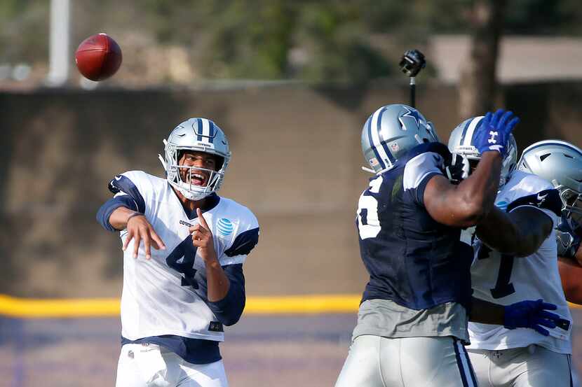 Cowboys quarterback Dak Prescott (4) attempts a pass during an afternoon practice at...