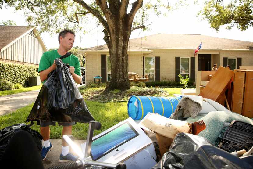 Kevin Jacobs cleared out his garage Saturday. Volunteers helped pack boxes of belongings. 