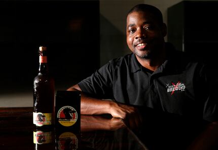 Deep Ellum Brewing Co.'s brewer, Barrett Tillman poses for a portrait with one of his...