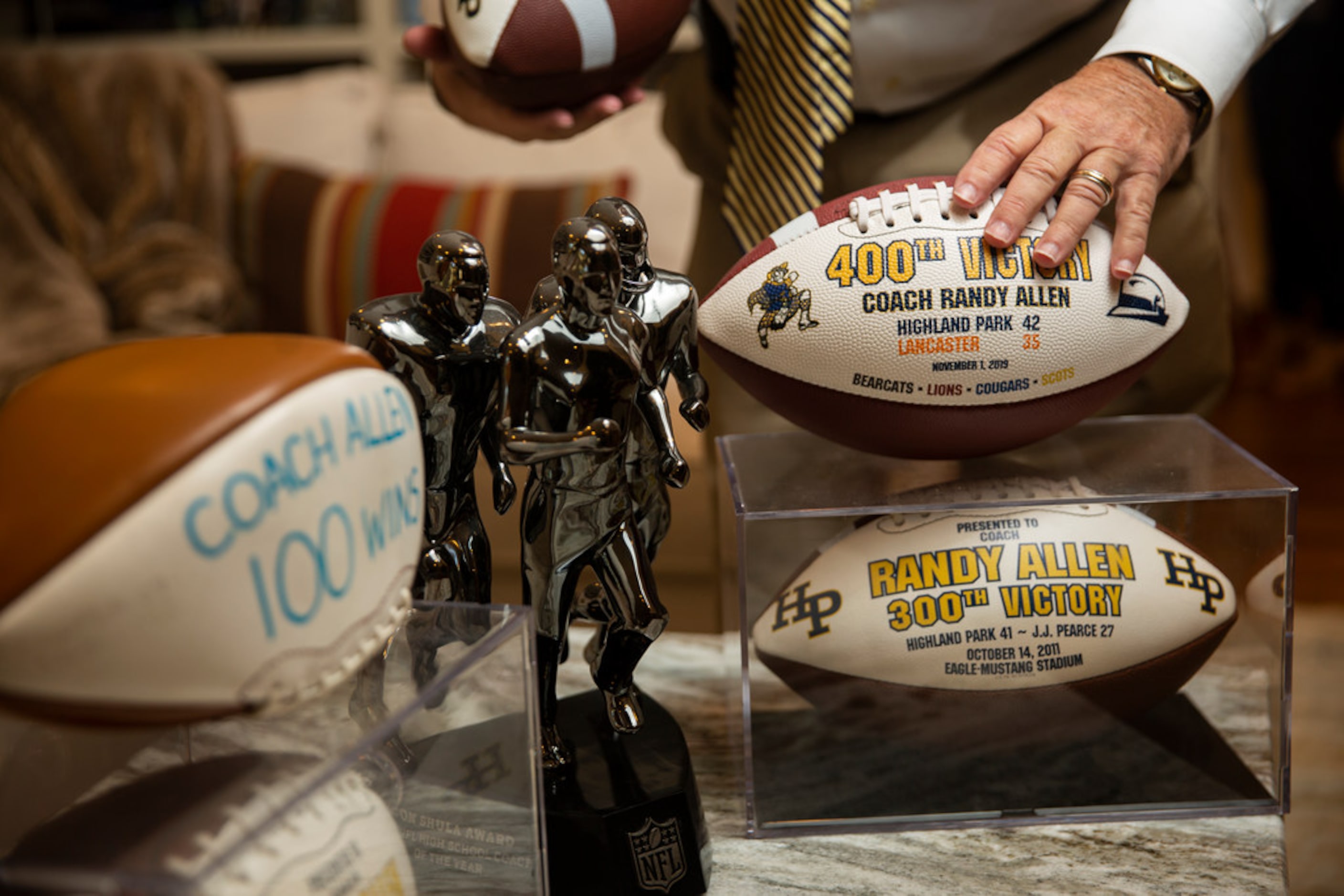 Highland Park football coach Randy Allen adjusts his 400th career victory ball in his...