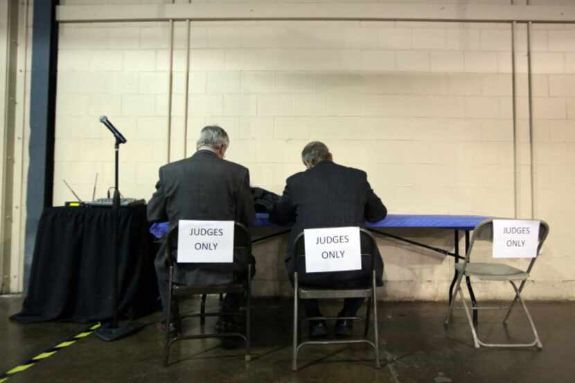 Two judges make their final vote at their own work station during the 2014 Dallas Regional...