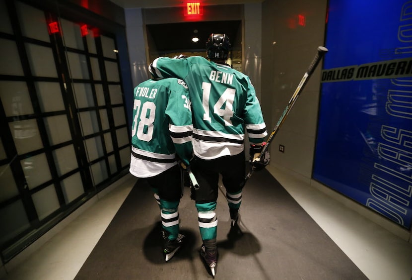 Dallas Stars left wing Jamie Benn (14) puts his arm around  teammate Vernon Fiddler (38) as...