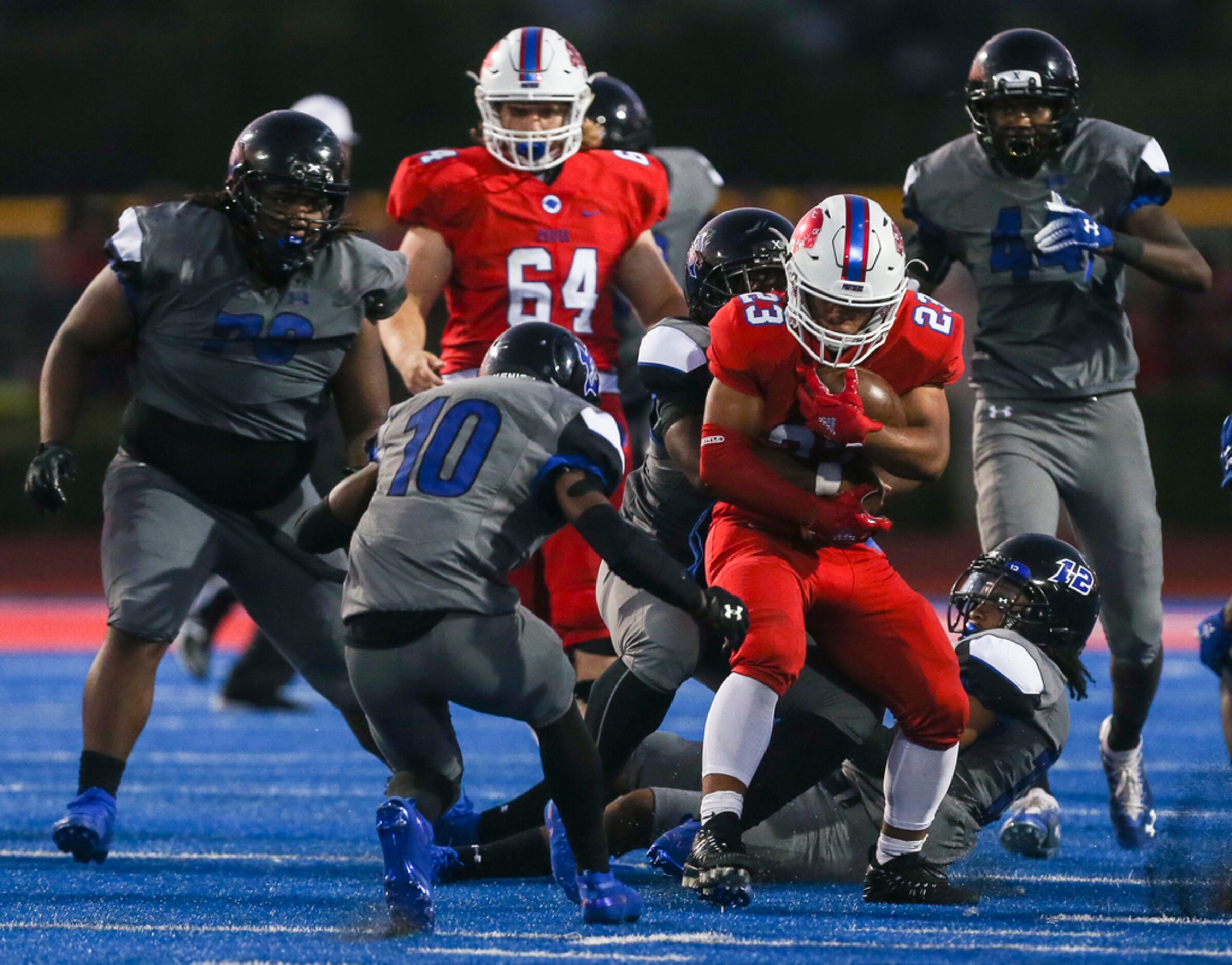 Parish Episcopal running back Christian Benson (23) works to break free from a Trinity...