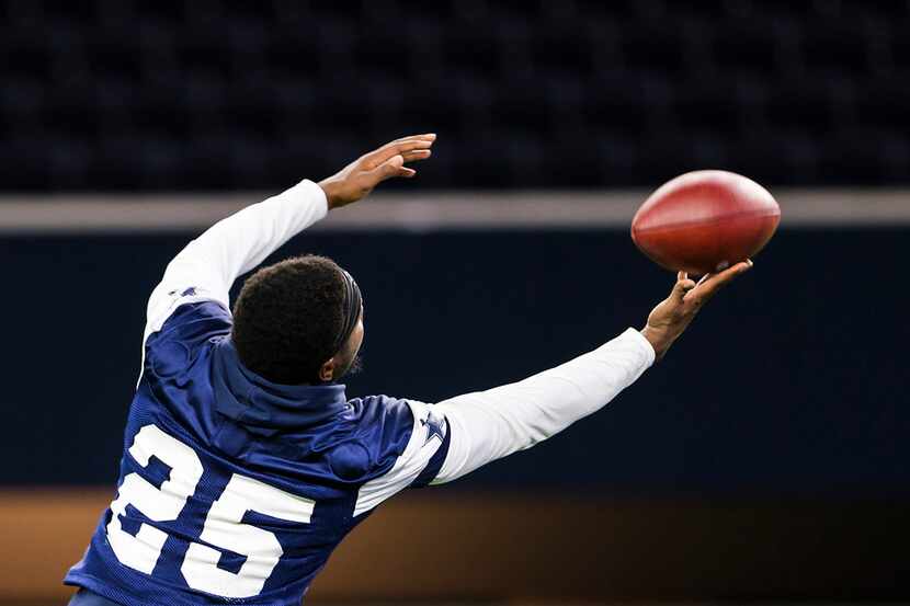 Dallas Cowboys safety Xavier Woods (25) reaches for a pass during a team OTA practice at The...