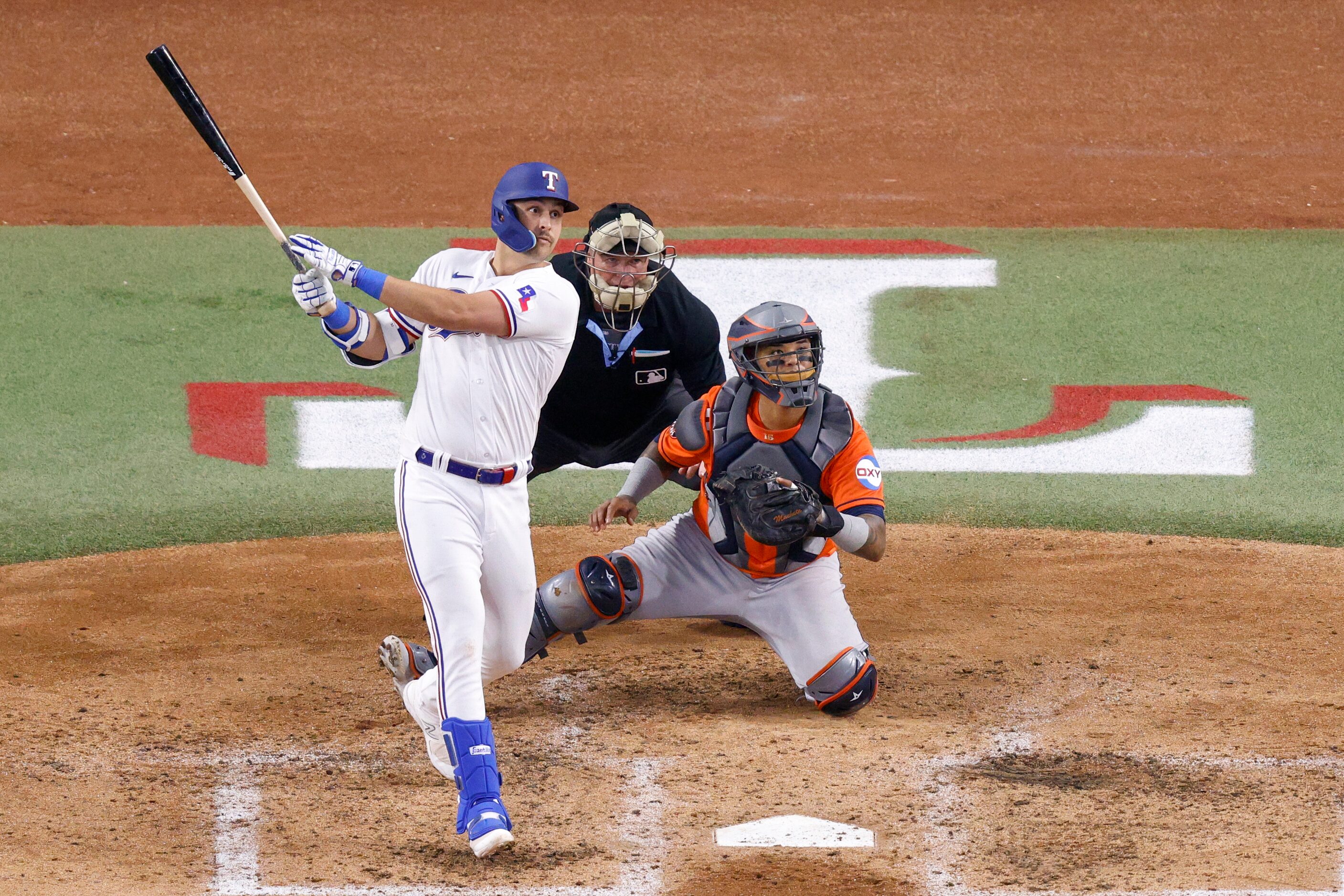 Texas Rangers first baseman Nathaniel Lowe (30) hits a home run off of Houston Astros...