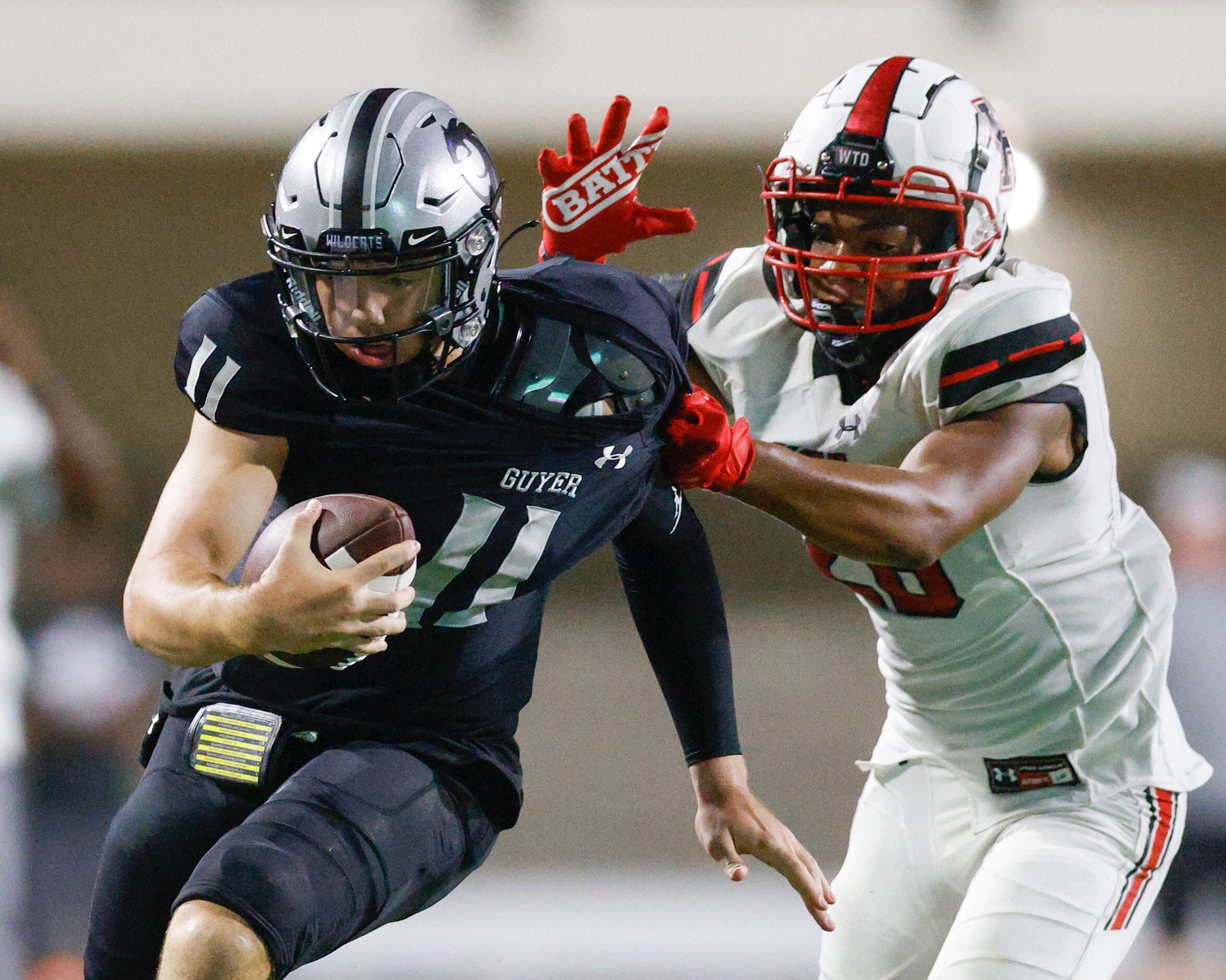 Rockwall-Heath defensive back Taurus Noles (28) tackles Denton Guyer quarterback Jackson...