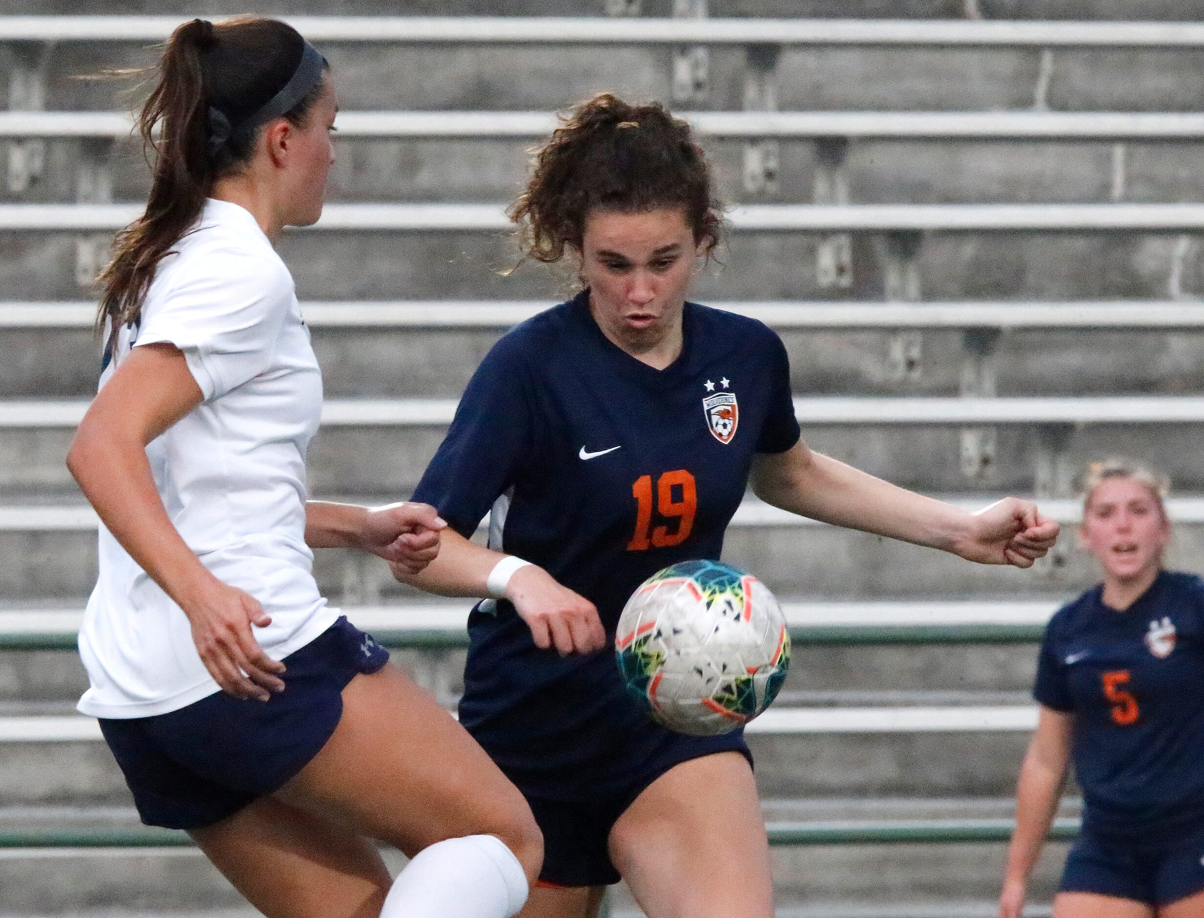 Wakeland midfielder Faith Bell (19) looks to pass as Highland Park forward Maja Davison (23)...