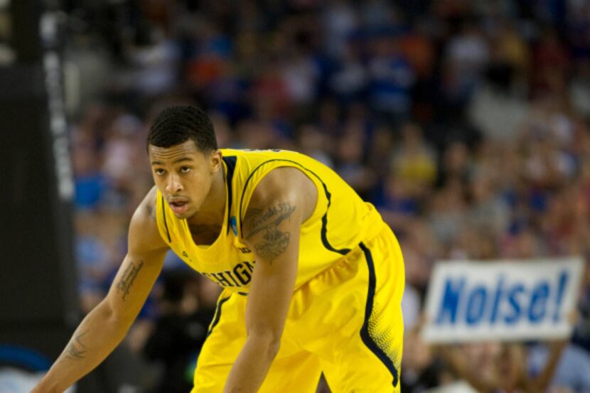 Trey Burke (3) of the University of Michigan Wolverines brings the ball up the court against...