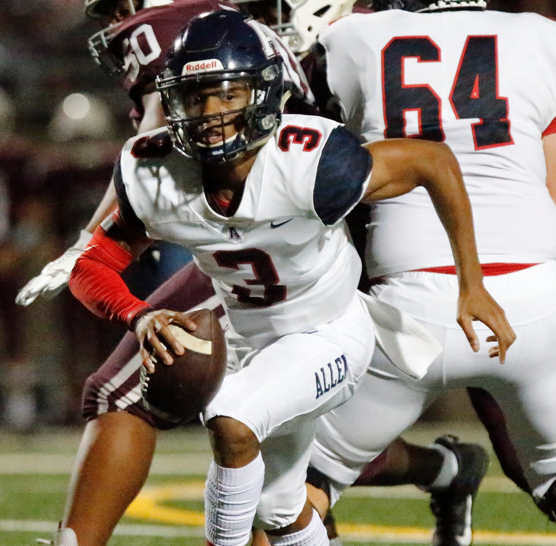 Allen High School quarterback Raylen Sharpe (3) runs for a first down during the first half...