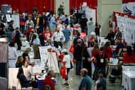 People walked by vendors inside the Expo Hall during the first day of the Texas GOP...