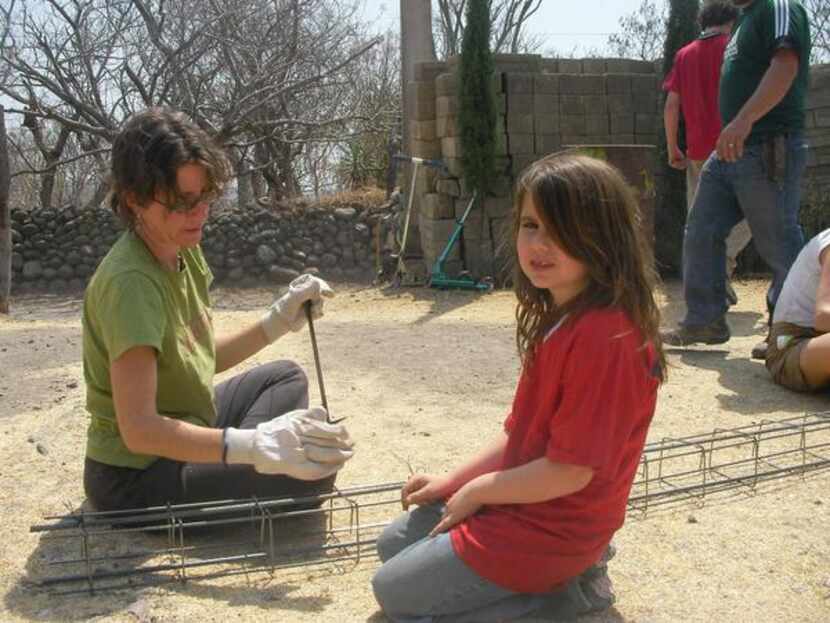 
Isabella helps prepare reinforcement pillars for a house wall in Mexico.
