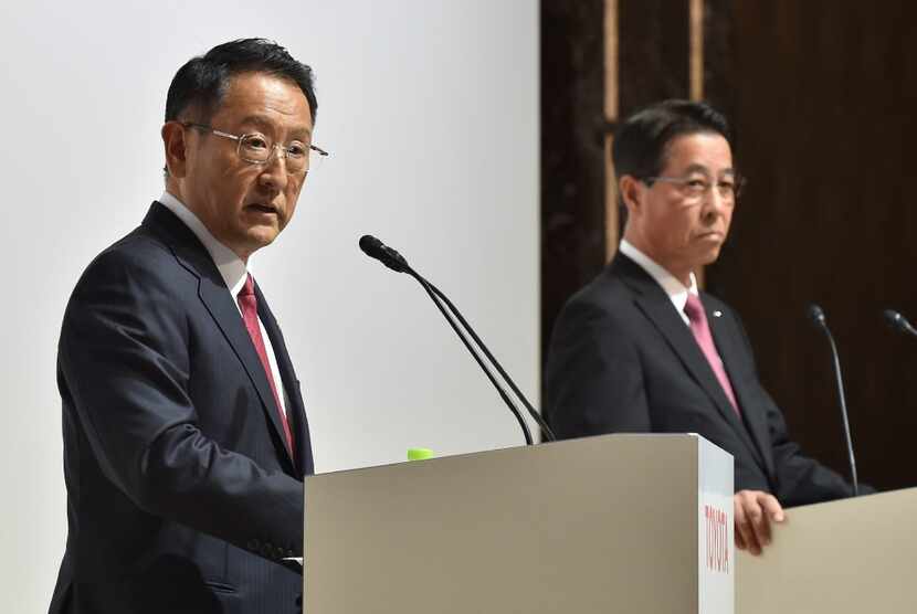 Toyota Motor Corporation President Akio Toyoda (L) answers questions as Mazda Motor...