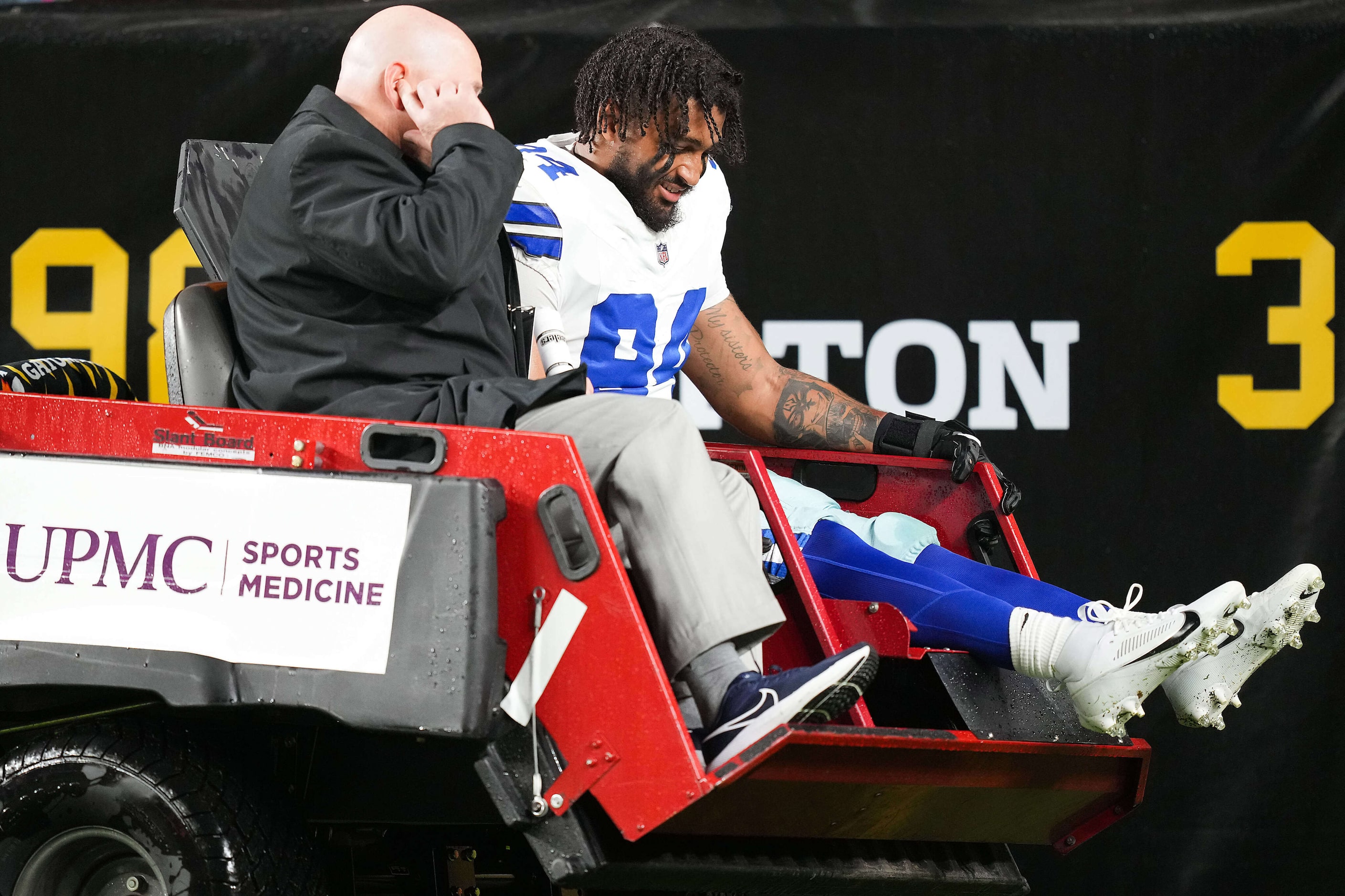 Dallas Cowboys defensive end Marshawn Kneeland (94) leaves the game on a cart during the...