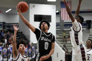 Denton Guyer guard Jordan Lowery (0) scores past Plano guard Justin Buenaventura (left) and...