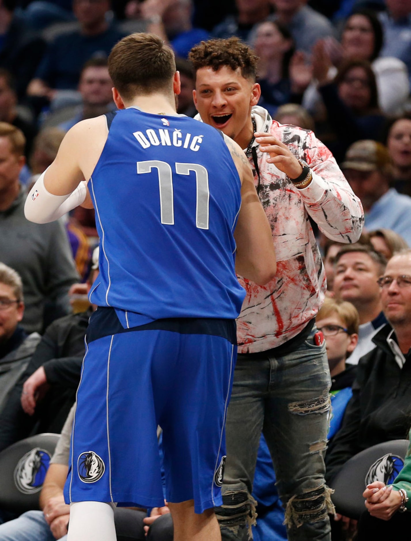 Dallas Mavericks guard Luka Doncic (77) greets Kansas City Chiefs Patrick Mahomes during a...