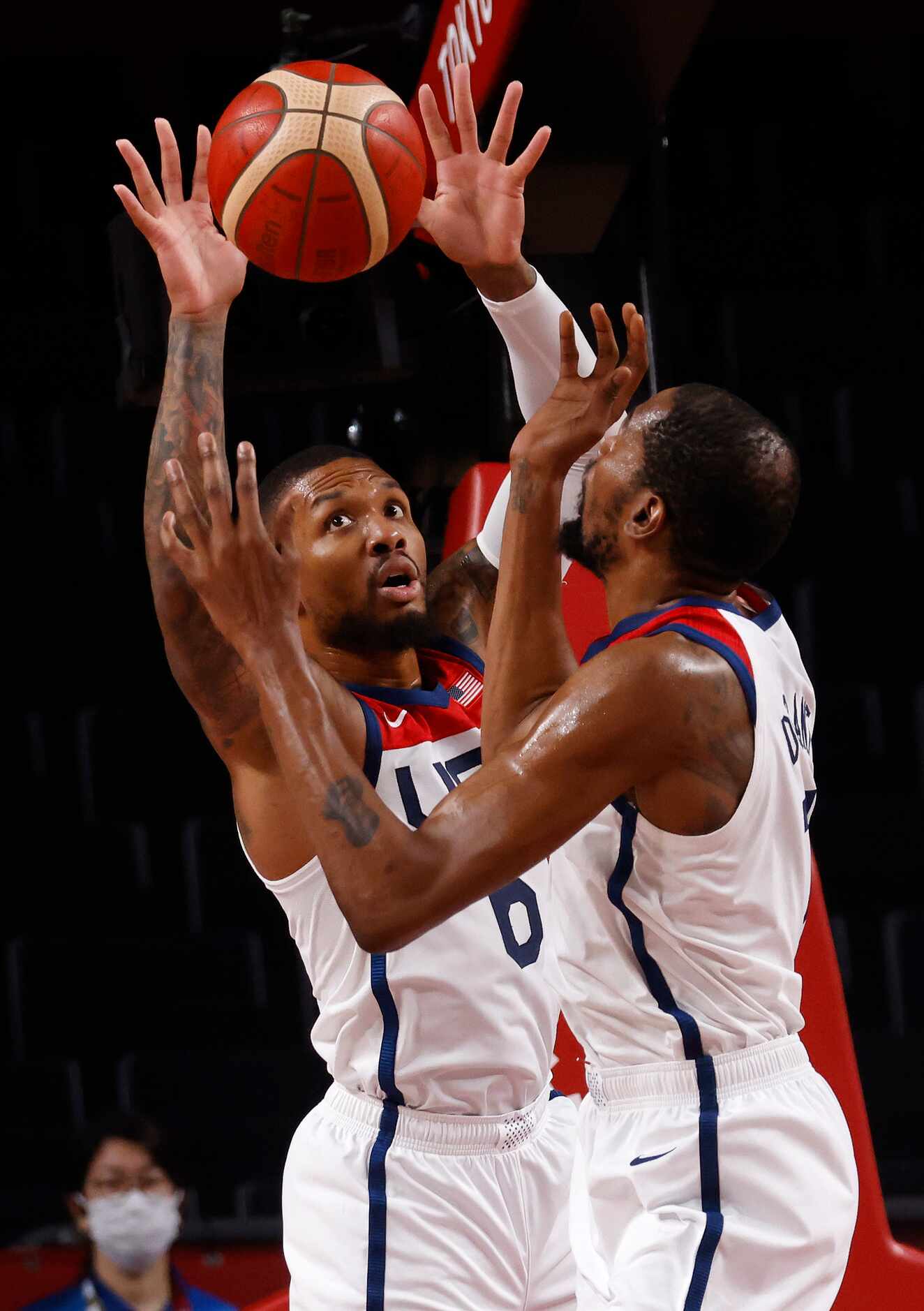 USA’s Kevin Durant (7) and Damian Lillard (6) go up for a rebound in a game against...