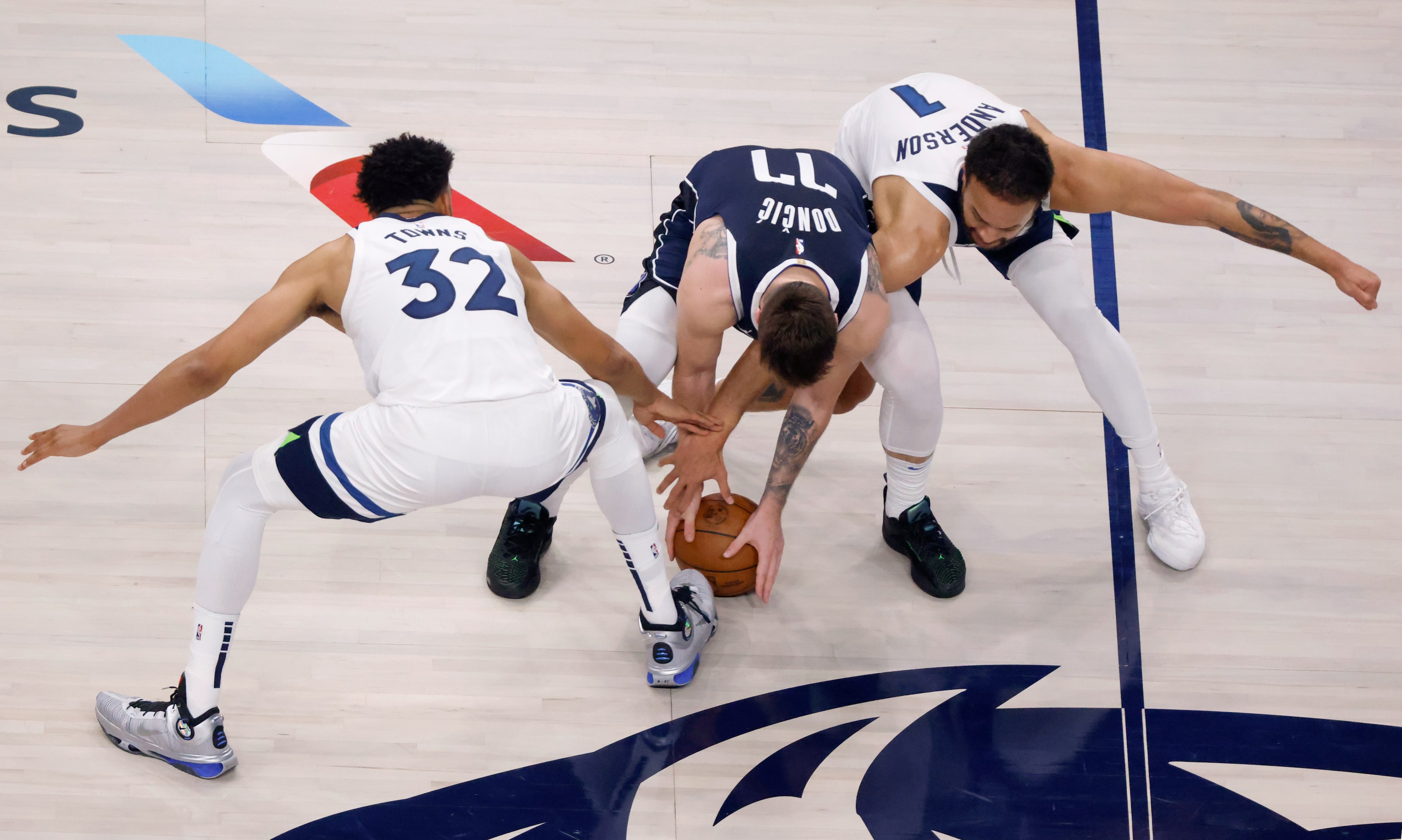 Minnesota Timberwolves center Karl-Anthony Towns (32) and forward Kyle Anderson (1) battle...