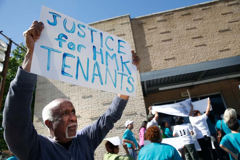 Ernest McMillan held up a protest sign in late April on behalf of HMK Ltd. tenants.