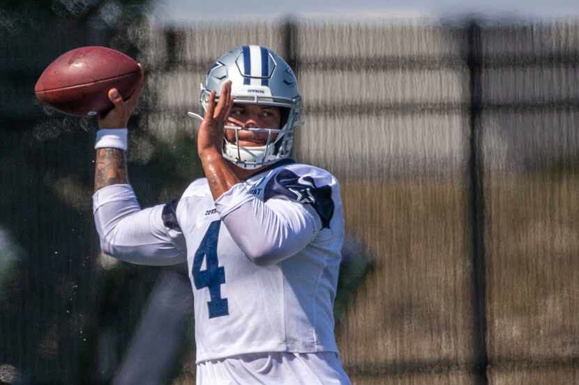 Dallas Cowboys quarterback Dak Prescott throws a pass during a practice at the Ford Center...