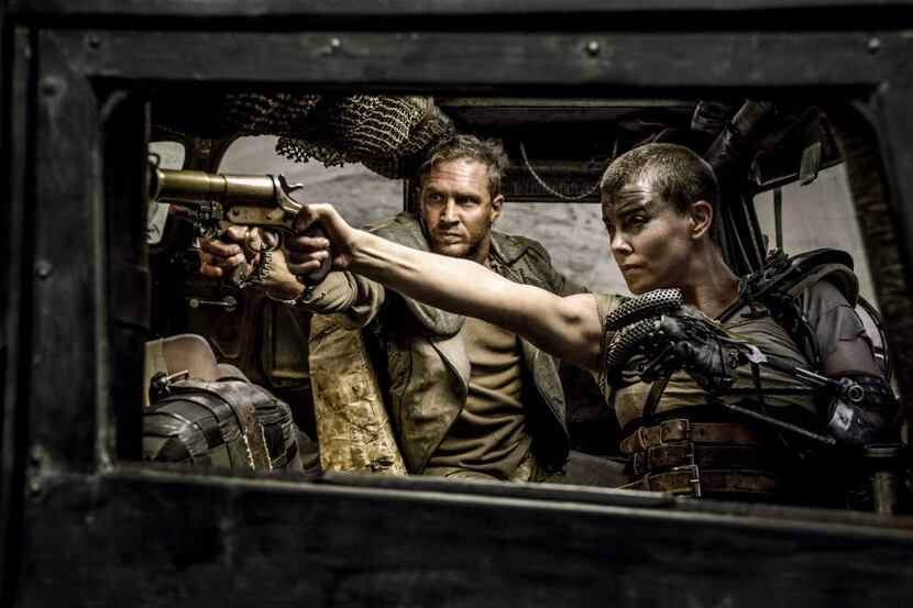 Tom Hardy, center, as Max Rockatansky and Charlize Theron, right, as Imperator Furiosa in ...