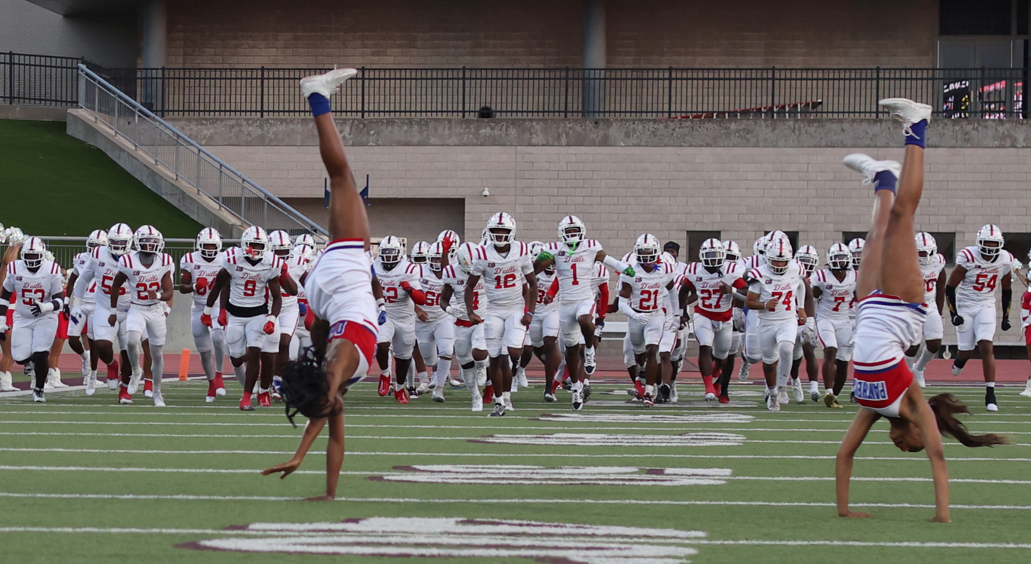 Duncanville players run onto the field before the opening kickoff of their game against...