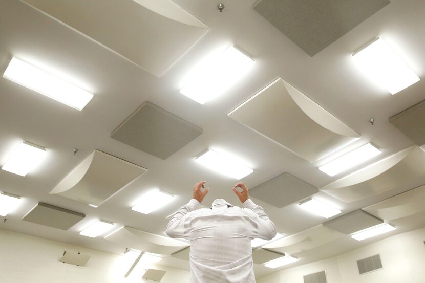 Dallas Opera music director Emmanuel Villaume, shown from behind, conducts during a...