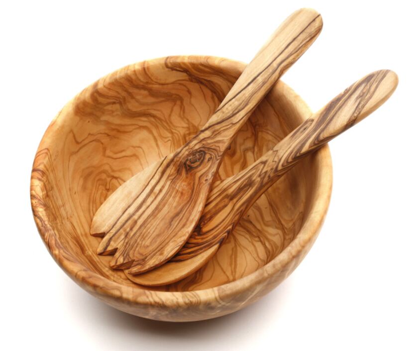 First serve: Mounded with ornaments or dressed salad greens, an olive wood serving bowl is a...