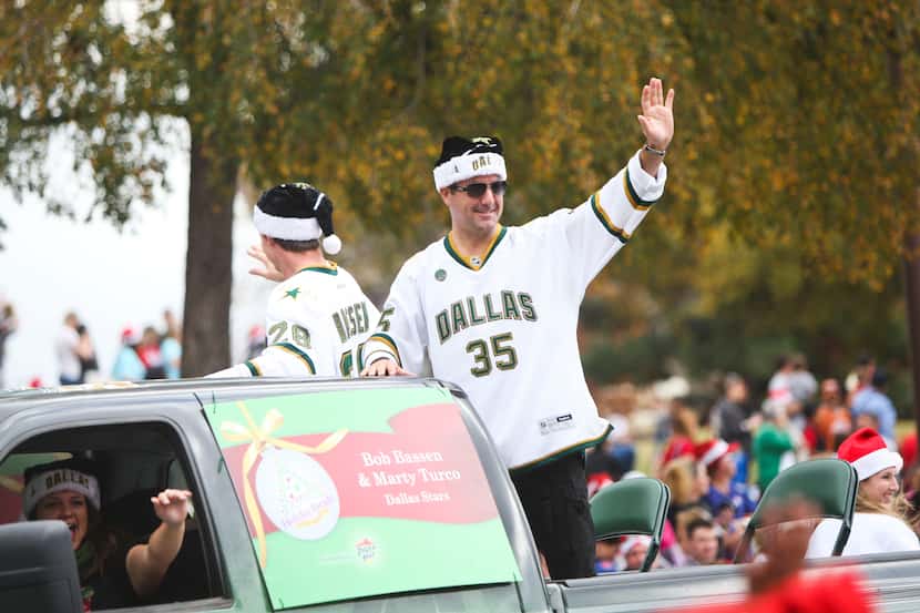 Marty Turco, right, and Bob Bassen of the Dallas Stars ride along the route of the 25th...
