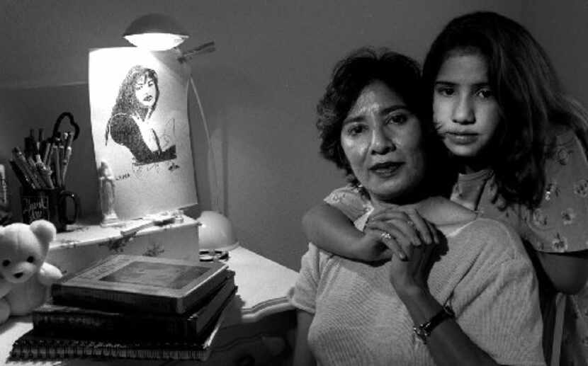 Natalie Niemann, right, and her  mother, Cris Mata-Neimann, left, sit in Natalie's room with...