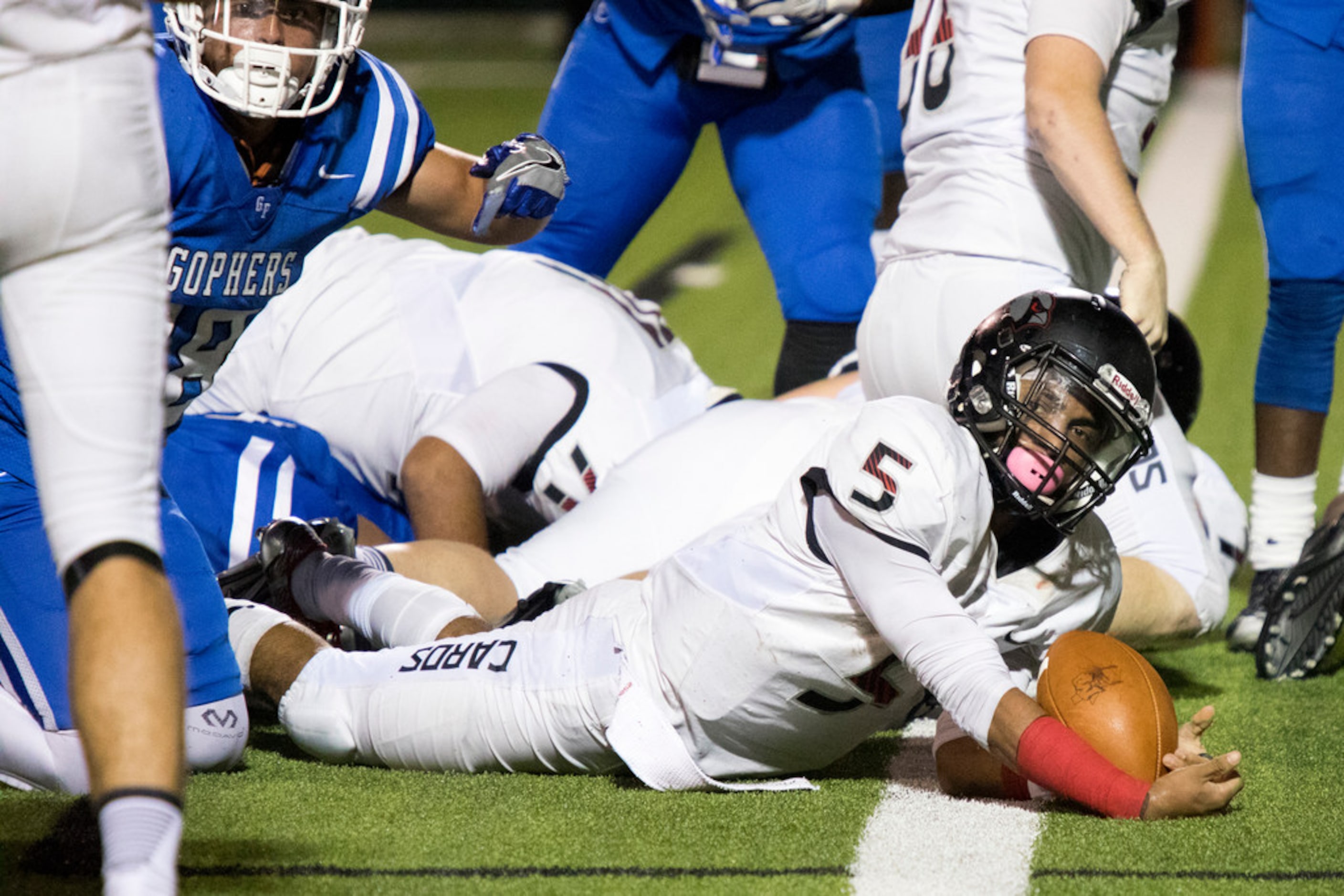 Irving MacArthur quarterback Brion Lopez (5) looks for confirmation of a touchdown during a...