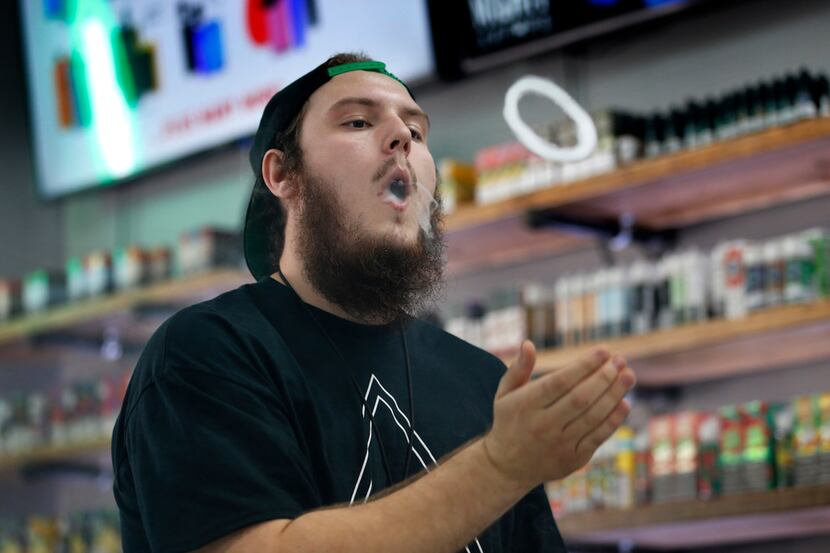 In this Sept. 3, 2019, photo, Devin Lambert, the manager at Good Guys Vape Shop,...