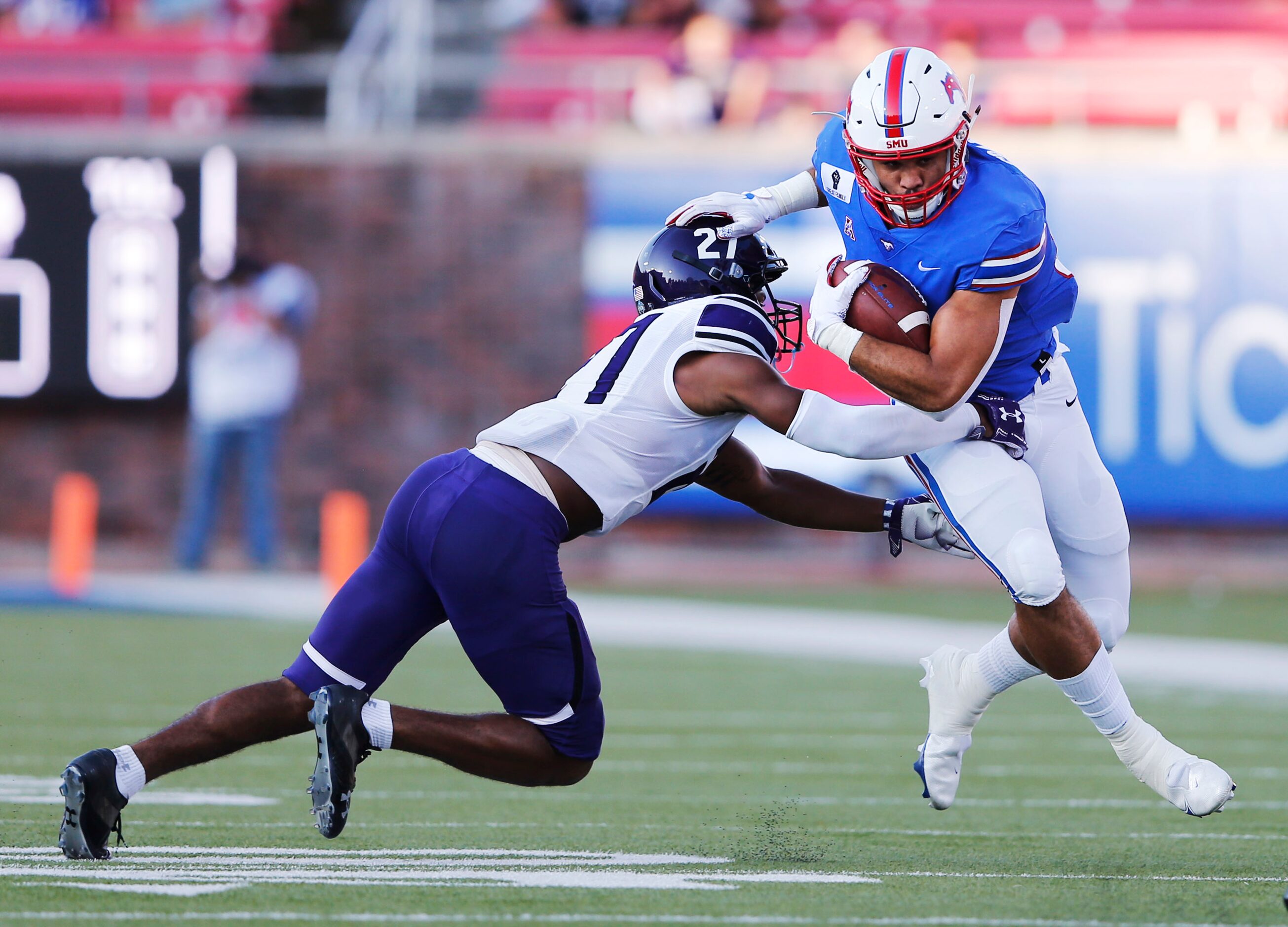 Southern Methodist Mustangs tight end Kylen Granson (83) stiff arms Stephen F. Austin...