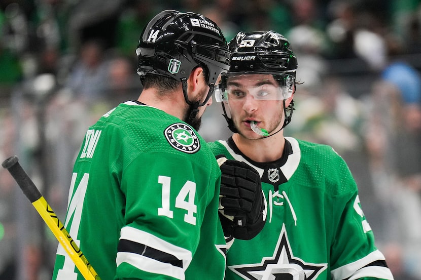 Dallas Stars center Wyatt Johnston (53) talks with left wing Jamie Benn (14) before a face...