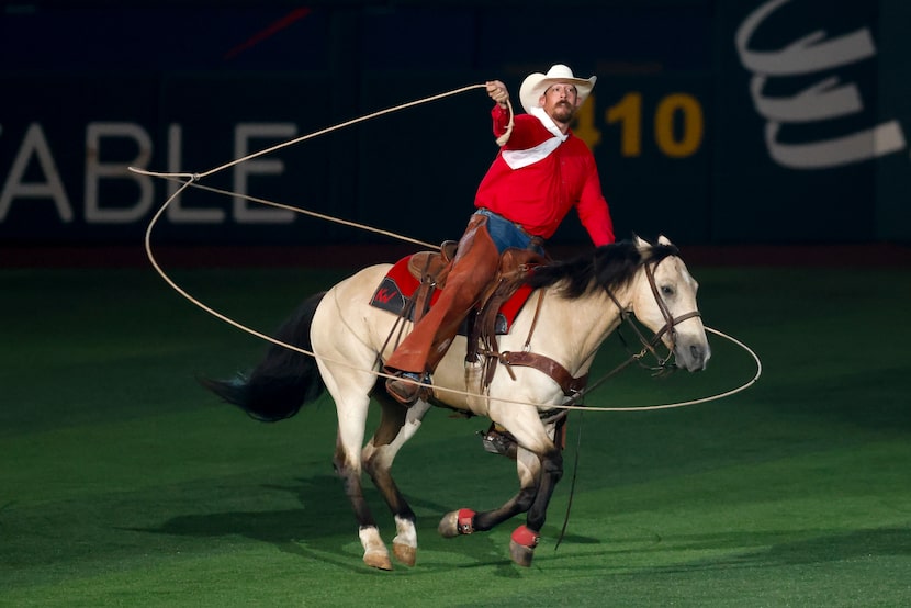 A trick-roper performs in the outfield at Globe Life Field before the MLB All-Star Game,...