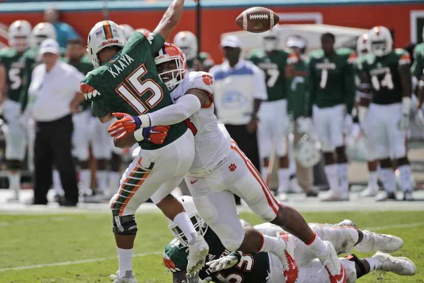 Clemson defensive end Kevin Dodd tackles Miami quarterback Brad Kaaya (15) as he passes...