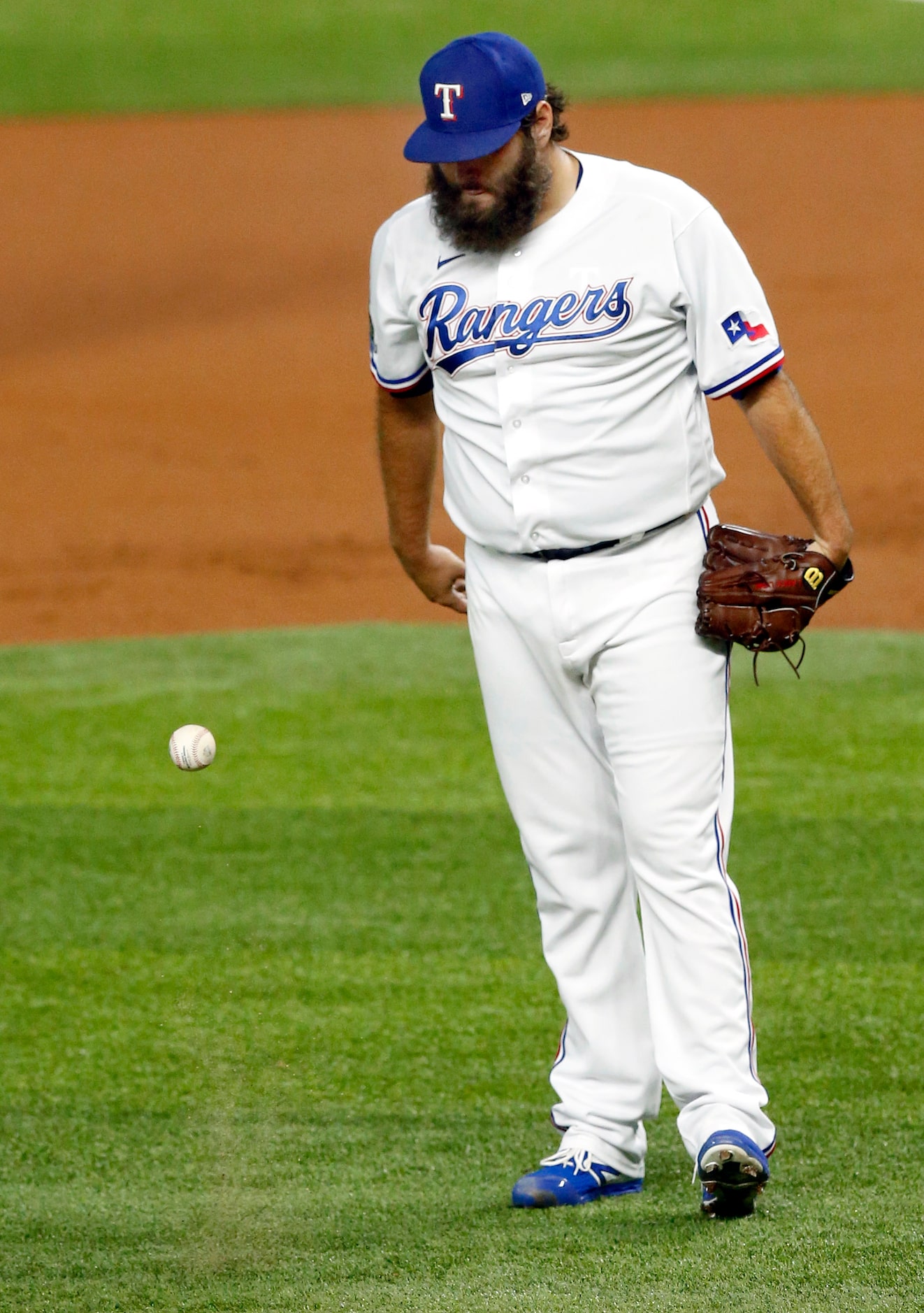 Texas Rangers starting pitcher Lance Lynn (35) pounds the ball off the turf after giving up...