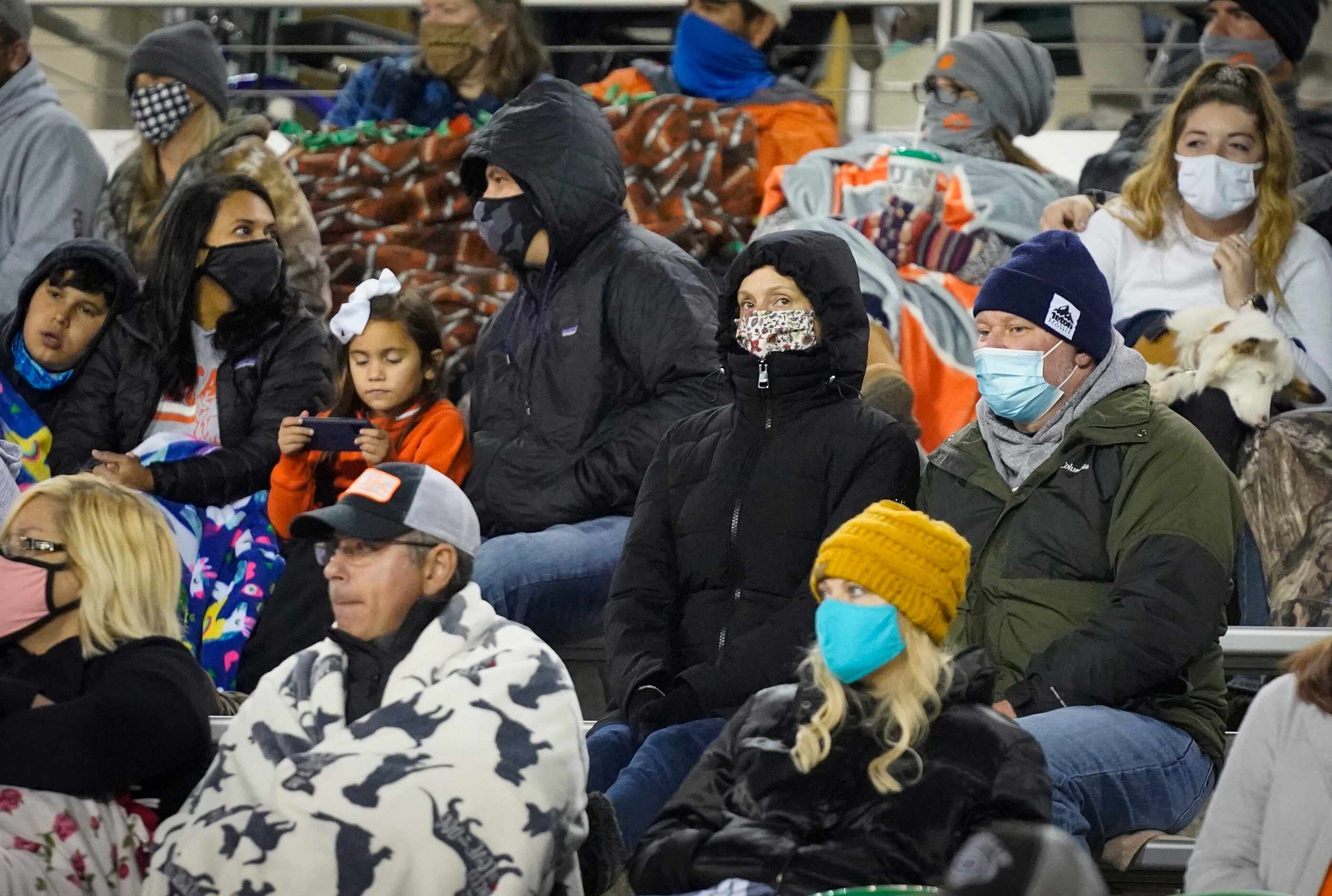 Celina fans bundle up against a chilly evening during the second half of a Class 4A Division...