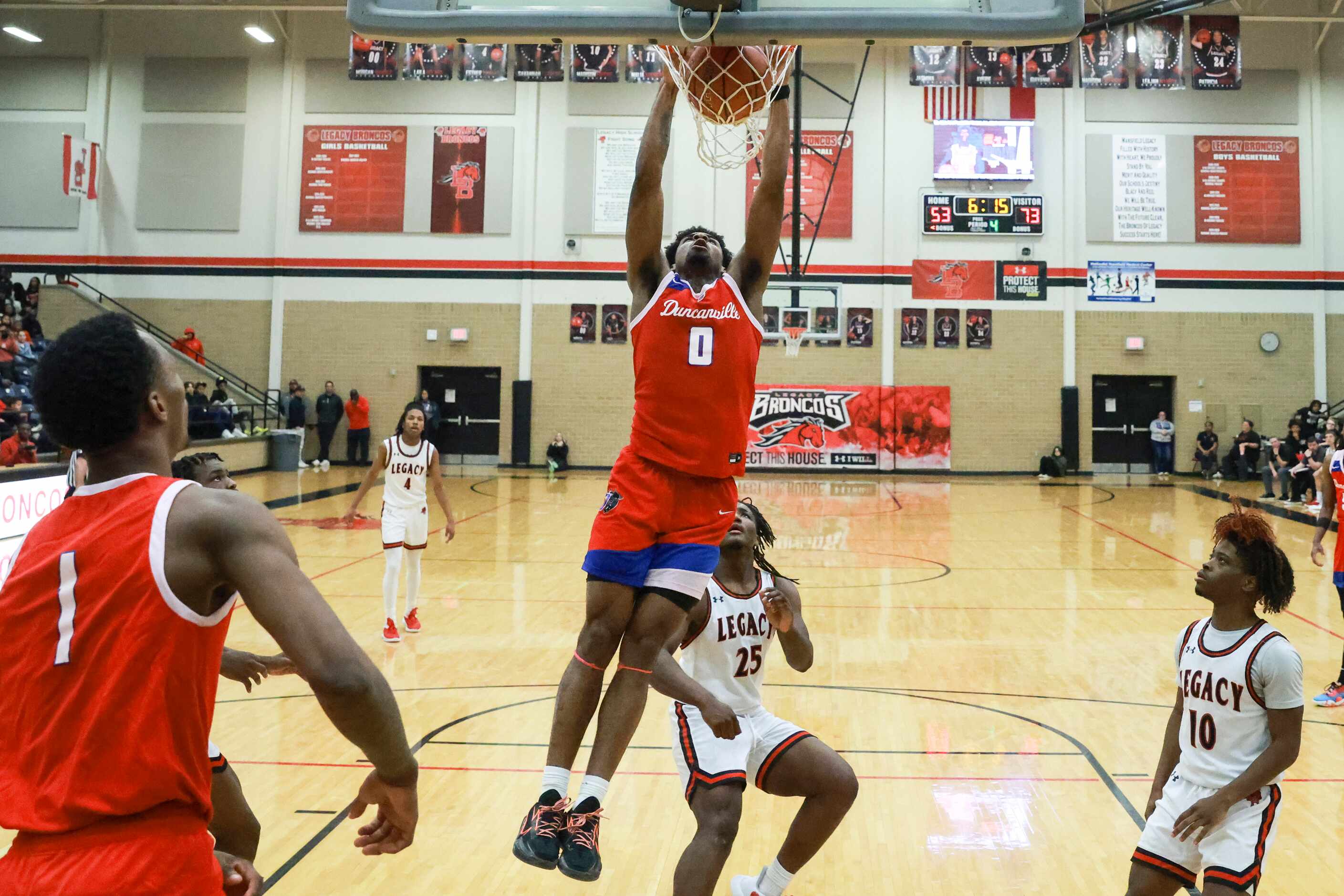 Duncanville High School’s K.J. Lewis (0) dunks during a game against Mansfield Legacy High...