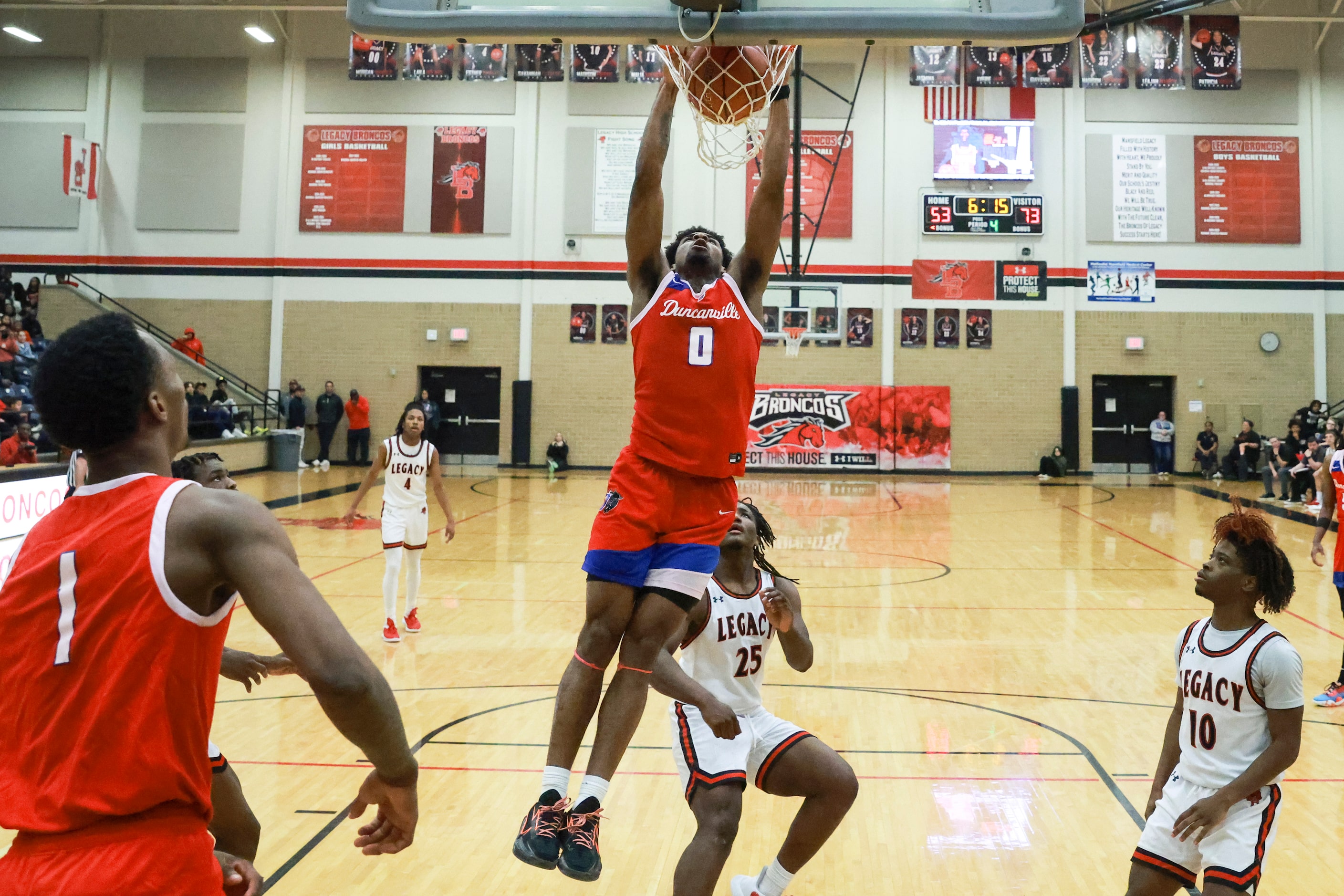 Duncanville High School’s K.J. Lewis (0) dunks during a game against Mansfield Legacy High...