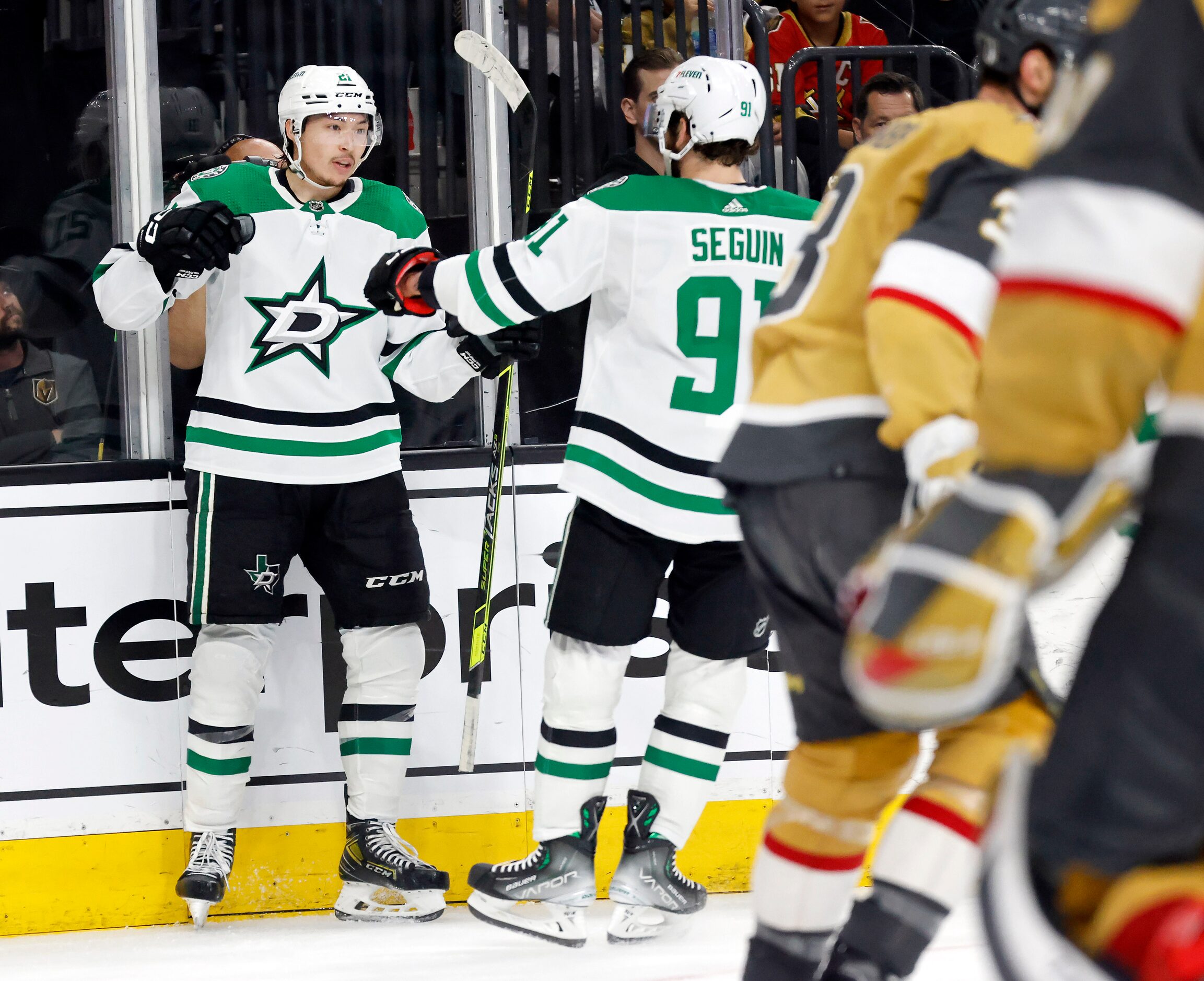 Dallas Stars left wing Jason Robertson (21) is congratulated by teammates after scoring...