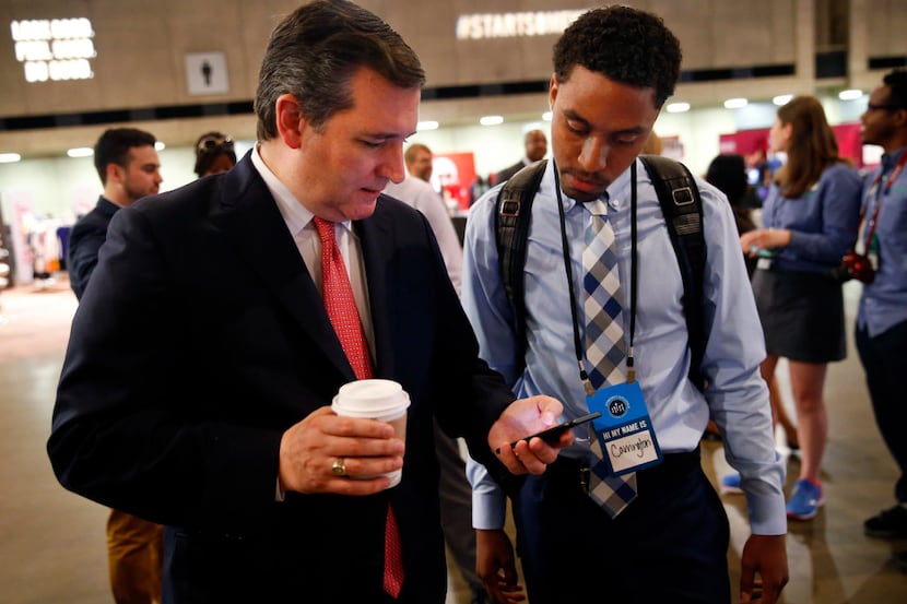 Texas Senator Ted Cruz (left) shares some information with Carrington Tatum, a Texas State...