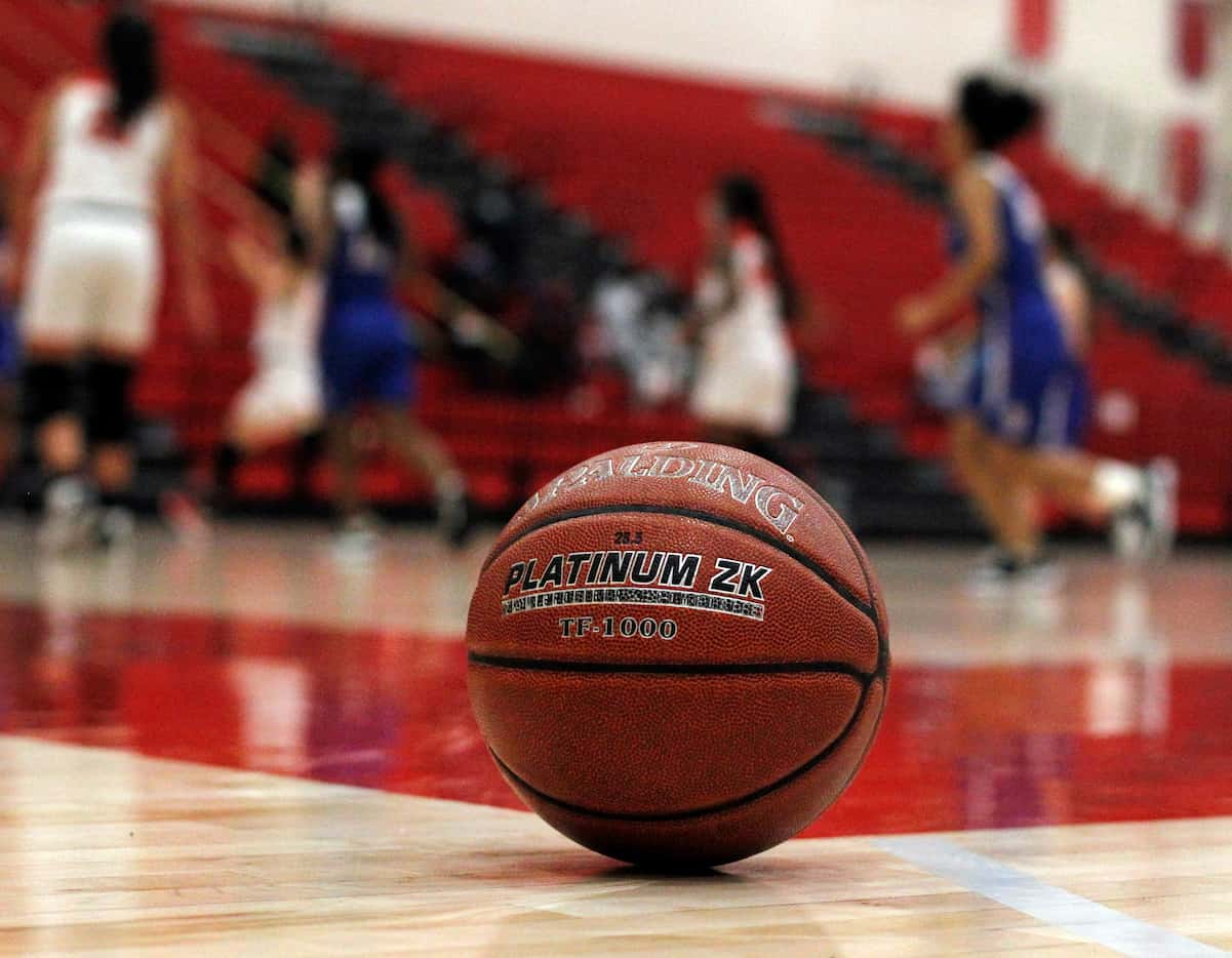 A basketball is pictured court-side during the second half of the Dallas Woodrow Wilson...